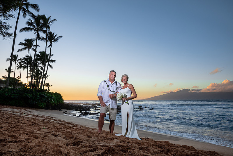 West Maui beach elopement at Napili Bay. Officiated by Kahu Kale Kaalekahi. Florals by Aloha Flower Co. Photography by Madelynne Lorraine.